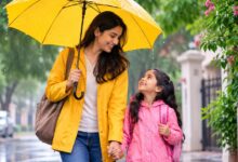 Mother protecting her child with an umbrella during the monsoon season