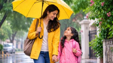 Mother protecting her child with an umbrella during the monsoon season