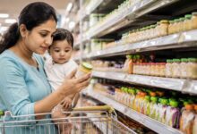 Mother reading baby food packaging labels while shopping for healthy baby food