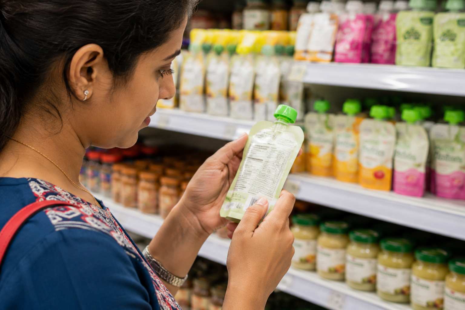 Parent checking the nutrition label on packaged baby food